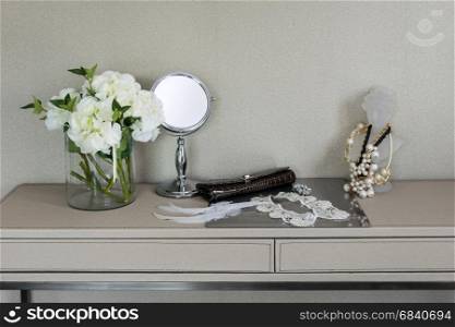 Beauty and make-up concept: mirror,jewelry and makeup set on a table