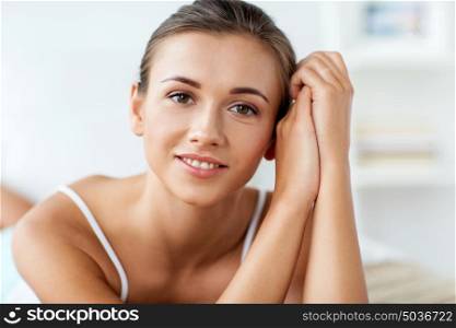 beauty and people concept - close up of beautiful happy young woman at home. close up of beautiful happy young woman at home