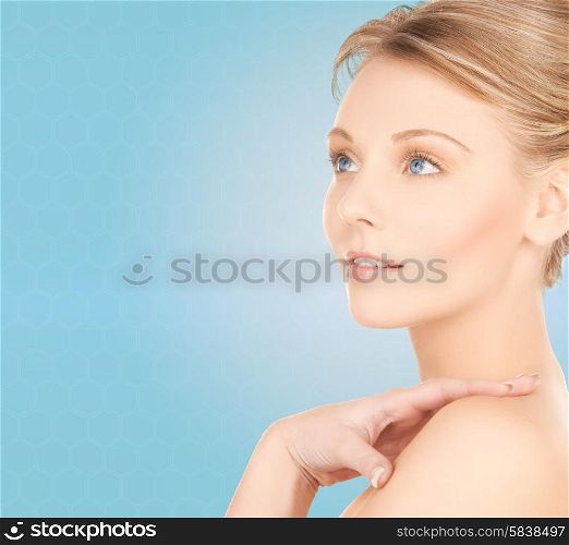 beauty and people concept - face of beautiful young woman over blue background