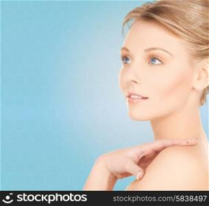 beauty and people concept - face of beautiful young woman over blue background