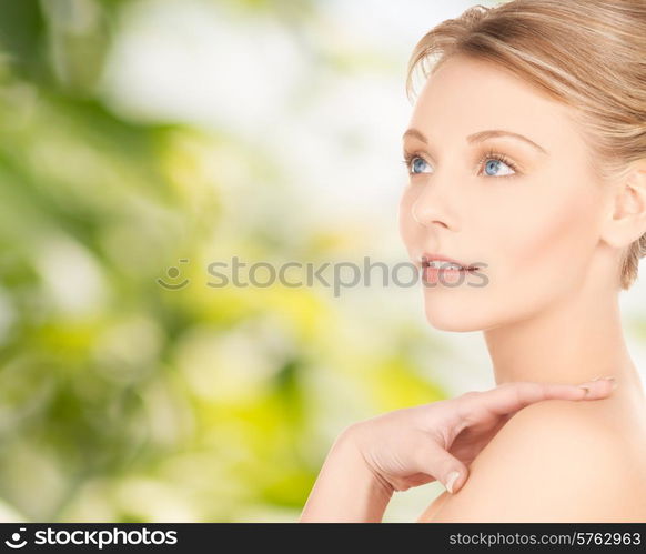 beauty and people concept - face of beautiful young woman over green background