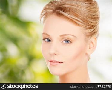 beauty and people concept - face of beautiful young woman over green background