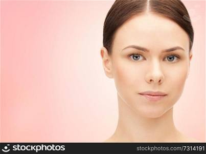 beauty and people concept - face of beautiful young woman over pink background. face of beautiful woman over pink background