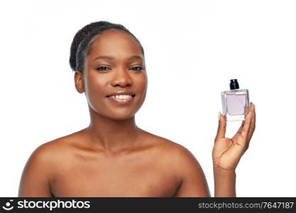 beauty and people concept - portrait of happy smiling young african american woman with bare shoulders with perfume over white background. young african american woman with perfume