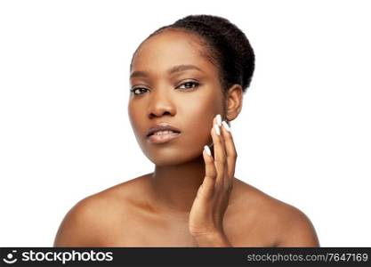 beauty and people concept - portrait of young african american woman with bare shoulders touching her face over white background. portrait of african woman touching her face
