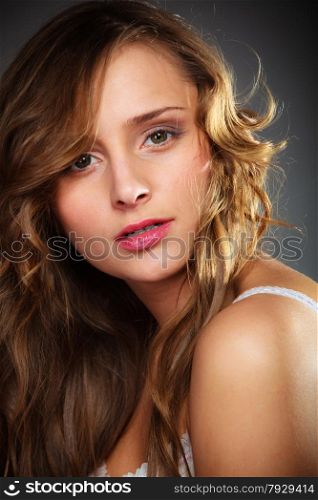 Beauty and sensuality of women. Young attractive long haired girl portrait on gray background.