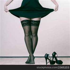 Beauty and sexuality of women. Sexy part body woman model wearing black dress skirt and pants stockings. Female legs with high heels.. Sexy woman legs in black