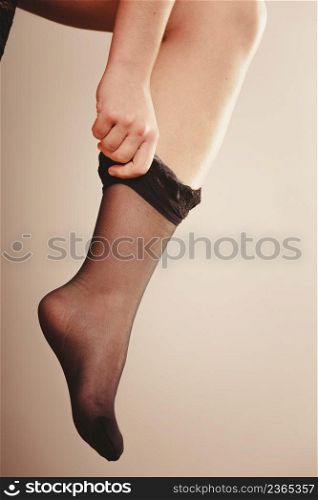 Beauty and sexuality of women. Sexy part body woman model wearing fit on black panties pants stockings. Close up of female legs.. Woman wearing black stockings