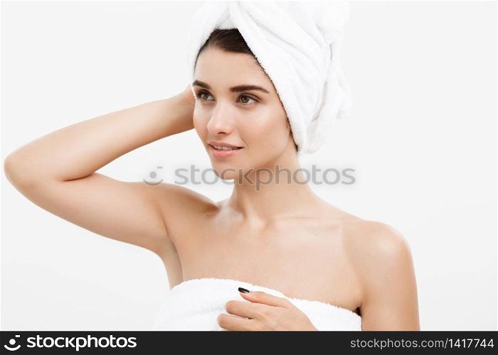 Beauty and Skin care concept - Beautiful caucasian Young Woman with bath towel on head covering her breasts, on white. Beauty and Skin care concept - Beautiful caucasian Young Woman with bath towel on head covering her breasts, on white.