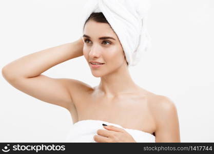 Beauty and Skin care concept - Beautiful caucasian Young Woman with bath towel on head covering her breasts, on white. Beauty and Skin care concept - Beautiful caucasian Young Woman with bath towel on head covering her breasts, on white.