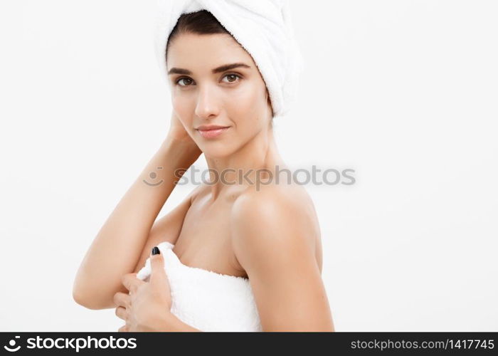Beauty and Skin care concept - Beautiful caucasian Young Woman with bath towel on head covering her breasts, on white. Beauty and Skin care concept - Beautiful caucasian Young Woman with bath towel on head covering her breasts, on white.