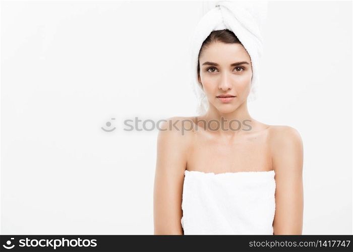 Beauty and Skin care concept - Beautiful caucasian Young Woman with bath towel on head covering her breasts, on white.. Beauty and Skin care concept - Beautiful caucasian Young Woman with bath towel on head covering her breasts, on white