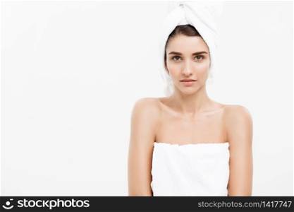 Beauty and Skin care concept - Beautiful caucasian Young Woman with bath towel on head covering her breasts, on white.. Beauty and Skin care concept - Beautiful caucasian Young Woman with bath towel on head covering her breasts, on white