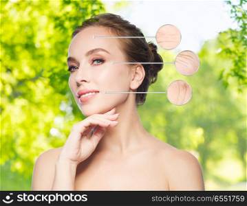 beauty and skin care concept - beautiful young woman touching her face over green natural background. beautiful young woman touching her face. beautiful young woman touching her face