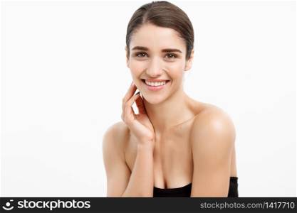 Beauty and Skin care concept - Close up Beautiful Young Woman touching her skin on white background. Beauty and Skin care concept - Close up Beautiful Young Woman touching her skin on white background.