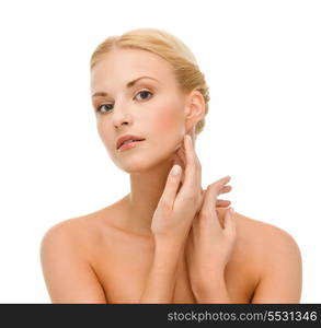 beauty and spa concept - face of beautiful woman touching her face skin