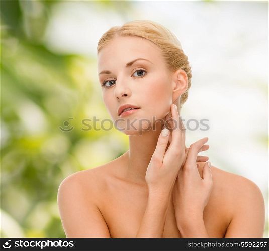 beauty and spa concept - face of beautiful woman touching her face skin