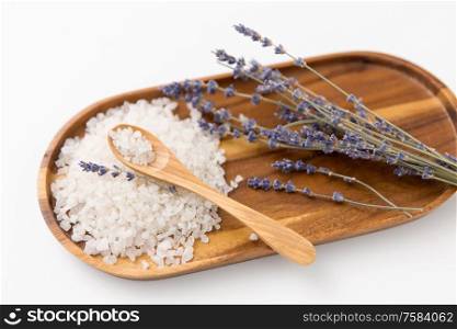 beauty and wellness concept - sea salt heap, lavender and spoon on wooden tray. sea salt heap, lavender and spoon on wooden tray