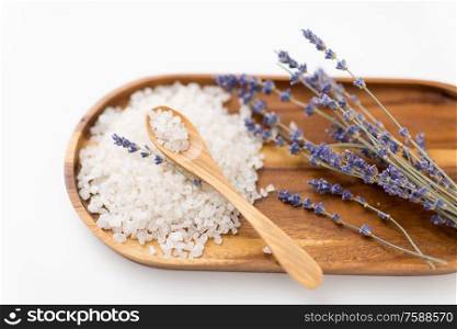 beauty and wellness concept - sea salt heap, lavender and spoon on wooden tray. sea salt heap, lavender and spoon on wooden tray