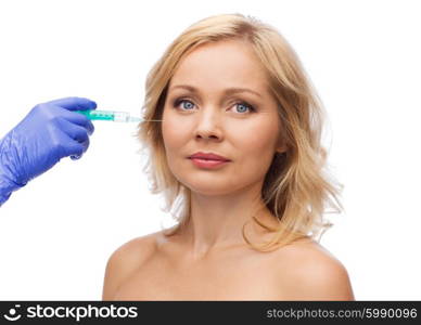 beauty, anti-aging cosmetic surgery concept - woman face and beautician hand in glove with syringe making injection to cheek