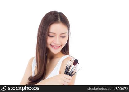 Beauty asian woman applying make up with brush on hand isolated on white background, beautiful of girl holding blusher, skincare and cosmetic concept.