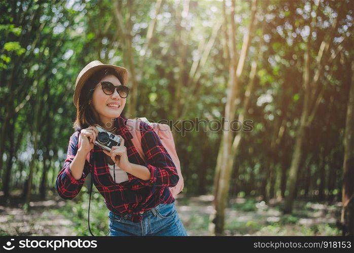 Beauty Asian woman smiling lifestyle portrait of pretty young woman having fun in outdoors summer with digital camera. Traveling of photographer concept. Hipster style and Solo woman theme.