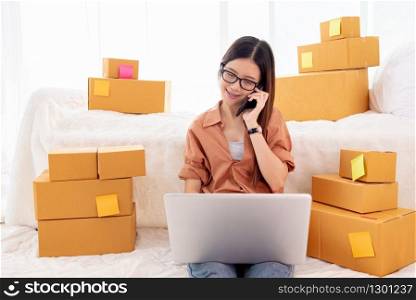 Beauty Asian woman using laptop and calling phone on bed. Business and Technology concept. Delivery and Online shopping concept. Post and Service theme. People lifestyle remote work in domestic house