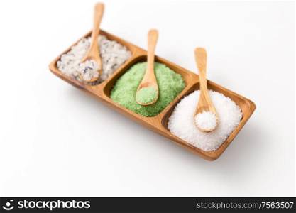 beauty, bath and wellness concept - sea salt and spoon on wooden tray. sea salt and spoons on wooden tray
