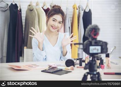 Beauty blogger video production for female fashion blog online cosmetic adviser record woman lifestyle tutorial. Trendy female vlogger showing how to use cosmetics products live via social media.