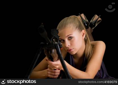 Beauty blond girl with a gun on a black background