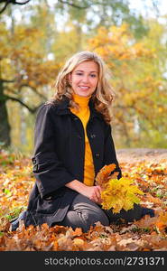 Beauty blond in the park in autumn