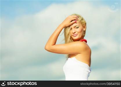 Beauty blonde woman portrait on sky background.. Natural beauty of women. Young attractive blonde woman on sky background. Portrait of gorgeous girl in summer time.