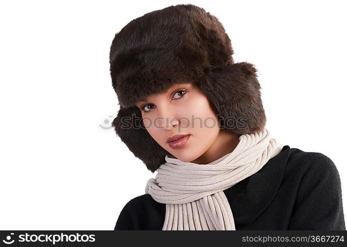 beauty close up portrait of cute female woman with fashion fur hat in winter dress with scarf looking at the camera against white background