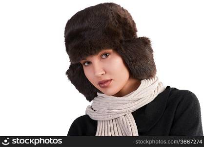 beauty close up portrait of cute female woman with fashion fur hat in winter dress with scarf looking at the camera against white background