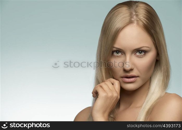 beauty close-up portrait of natural girl with blonde smooth hair, perfect skin and naked shoulder, looking in camera