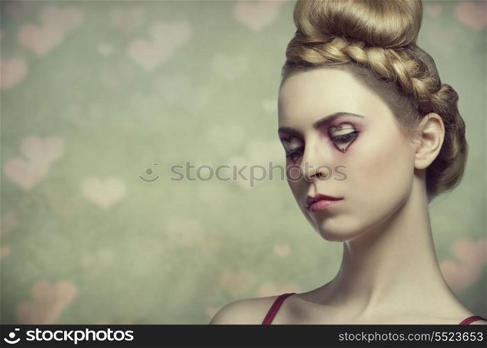 beauty close-up portrait of sensual woman with blonde creative hair-style and valentines heart shaped make-up