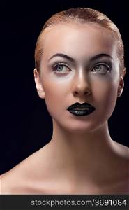""beauty close-up portrait on dark background of sensual young girl with black lipstick, bright eye make-up; naked shoulders and blonde hair""