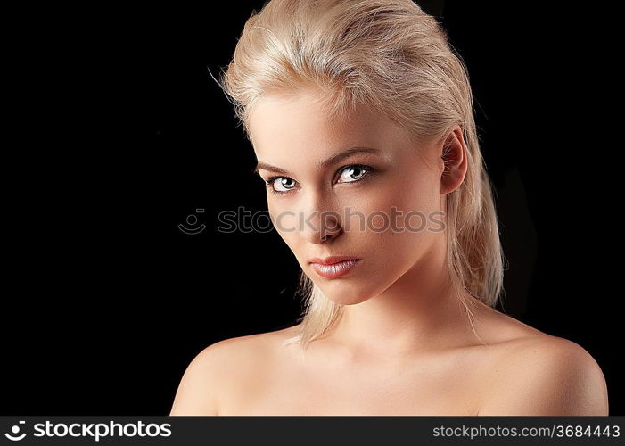 beauty closeup portrait of a young woman blonde woman looking straight into the camera