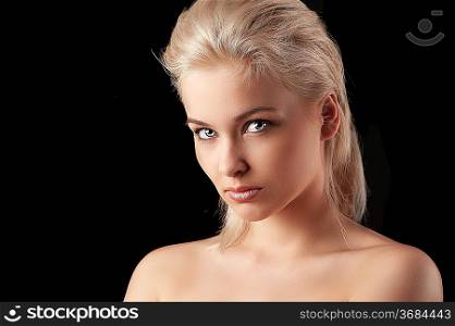 beauty closeup portrait of a young woman blonde woman looking straight into the camera
