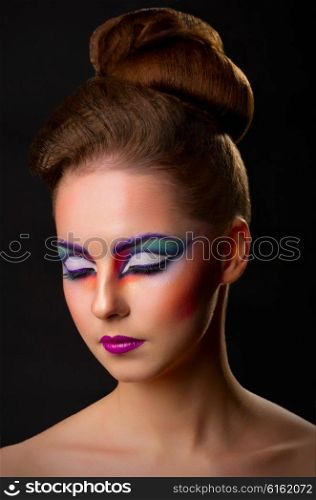 Beauty closeup portrait of young girl with makeup on black