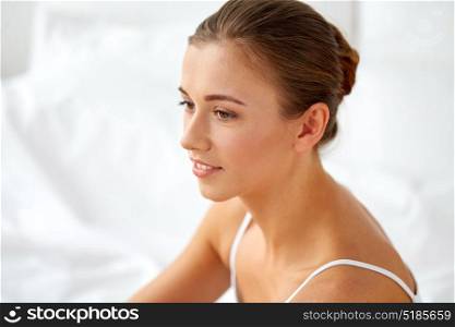 beauty, comfort and people concept - close up of beautiful happy young woman at home. close up of beautiful happy young woman at home