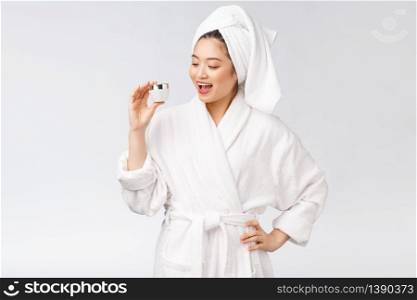 Beauty concept. Asian pretty woman with perfect skin holding cosmetic bottle. Beauty concept. Asian pretty woman with perfect skin holding cosmetic bottle.