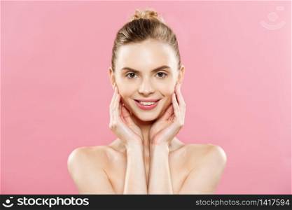 Beauty Concept - Beautiful Caucasian woman with clean skin, natural make-up isolated on bright pink background with copy space. Beauty Concept - Beautiful Caucasian woman with clean skin, natural make-up isolated on bright pink background with copy space.
