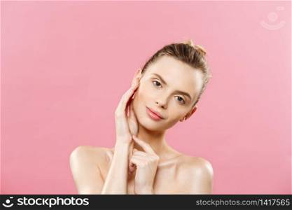 Beauty Concept - Beautiful Woman with Clean Fresh Skin close up on pink studio. Skin care face. Cosmetology. Beauty Concept - Beautiful Woman with Clean Fresh Skin close up on pink studio. Skin care face. Cosmetology.
