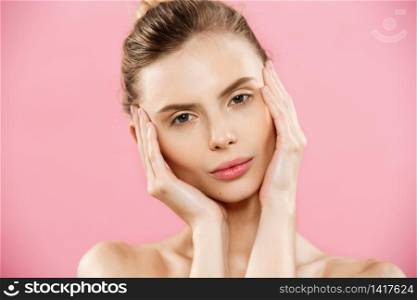 Beauty Concept - Close up Portrait of attractive caucasian girl with beauty natural skin isolated on pink background with copy space. Beauty Concept - Close up Portrait of attractive caucasian girl with beauty natural skin isolated on pink background with copy space.