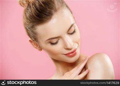 Beauty Concept - Close up Portrait of attractive caucasian girl with beauty natural skin isolated on pink background with copy space. Beauty Concept - Close up Portrait of attractive caucasian girl with beauty natural skin isolated on pink background with copy space.