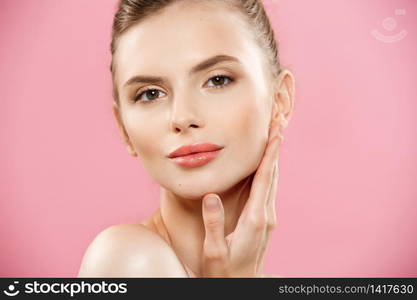 Beauty Concept - Close up Portrait of attractive caucasian girl with beauty natural skin isolated on pink background with copy space. Beauty Concept - Close up Portrait of attractive caucasian girl with beauty natural skin isolated on pink background with copy space.