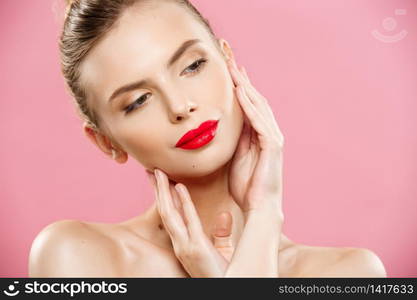 Beauty concept - Gorgeous Young Brunette Woman face portrait. Beauty Model Girl with bright eyebrows, perfect make-up, red lips, touching her face. Isolated on pink background. Beauty concept - Close up Gorgeous Young Brunette Woman face portrait. Beauty Model Girl with bright eyebrows, perfect make-up, red lips, touching her face. Isolated on pink background