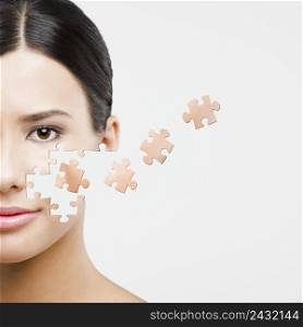 Beauty concept of a beautiful Asian woman with puzzle pieces in the face