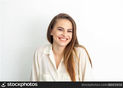 Beauty concept of woman. Portrait of a happy charming shy smiling young caucasian woman with long brown hair posing and looking at the camera over white background. Beauty concept of woman. Portrait of a happy charming shy smiling young caucasian woman with long brown hair posing and looking at the camera over white background.